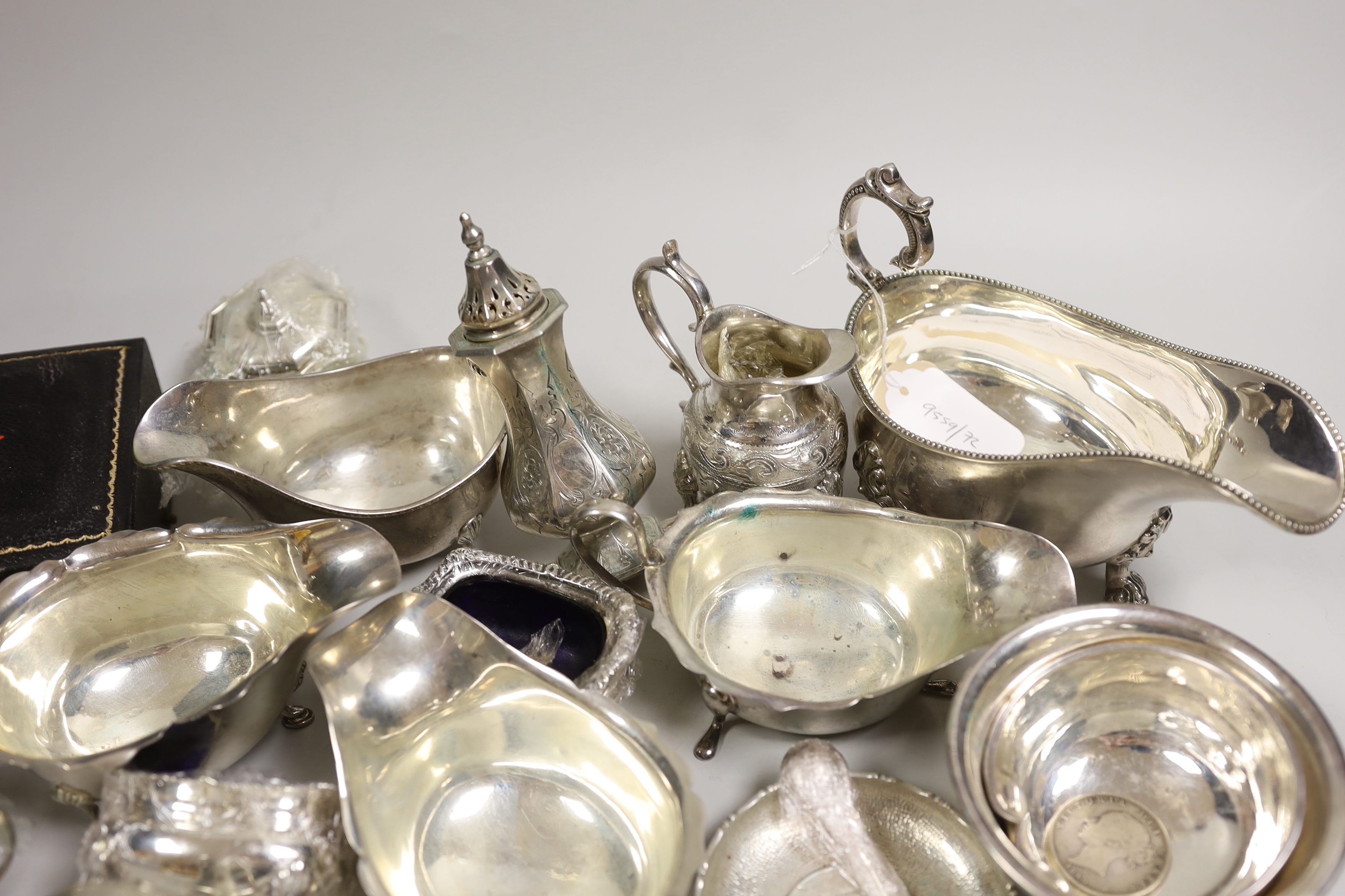 A mixed collection of small silver and plated items to include five various sauceboats, a cased pair of pepper pots, a chased Victorian sugar sifter, two caddy spoons, a silver mounted peppermill, two Chinese coin-set tr